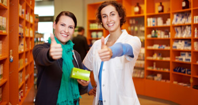 customer and pharmacist showing thumbs up